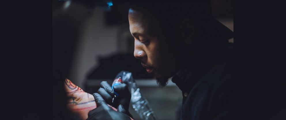 PHOTO: Richard Parker, founder of Think Before You Ink tattoo studio in New York City, works with a client in March 2018.