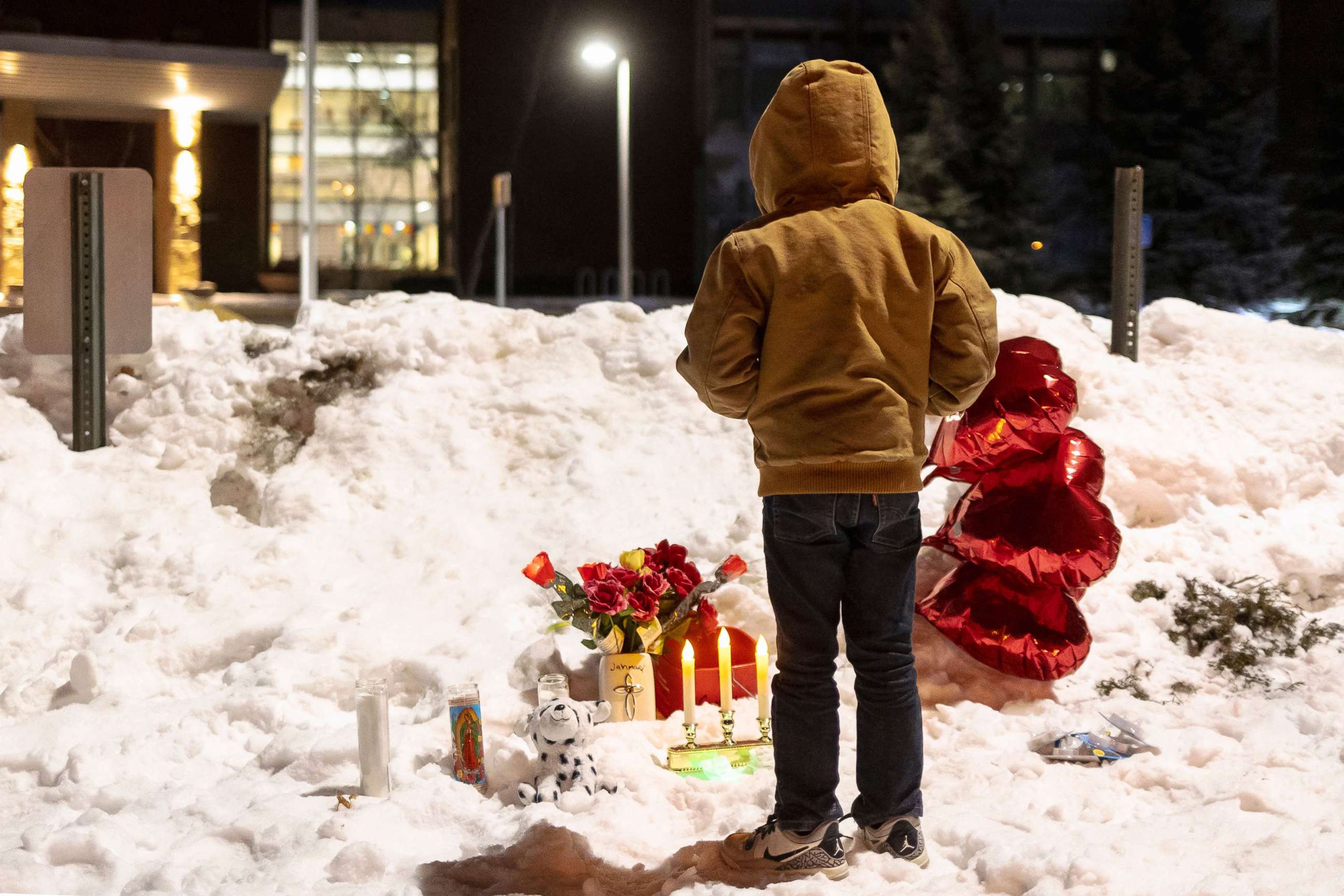 PHOTO: A young boy participate in a candlelight vigil for the victims of a school shooting in front of South Education Center Academy in Richfield, Minn., Feb. 1, 2022. 