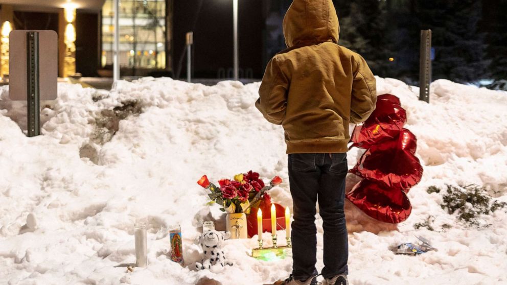 PHOTO: A young boy participate in a candlelight vigil for the victims of a school shooting in front of South Education Center Academy in Richfield, Minn., Feb. 1, 2022. 