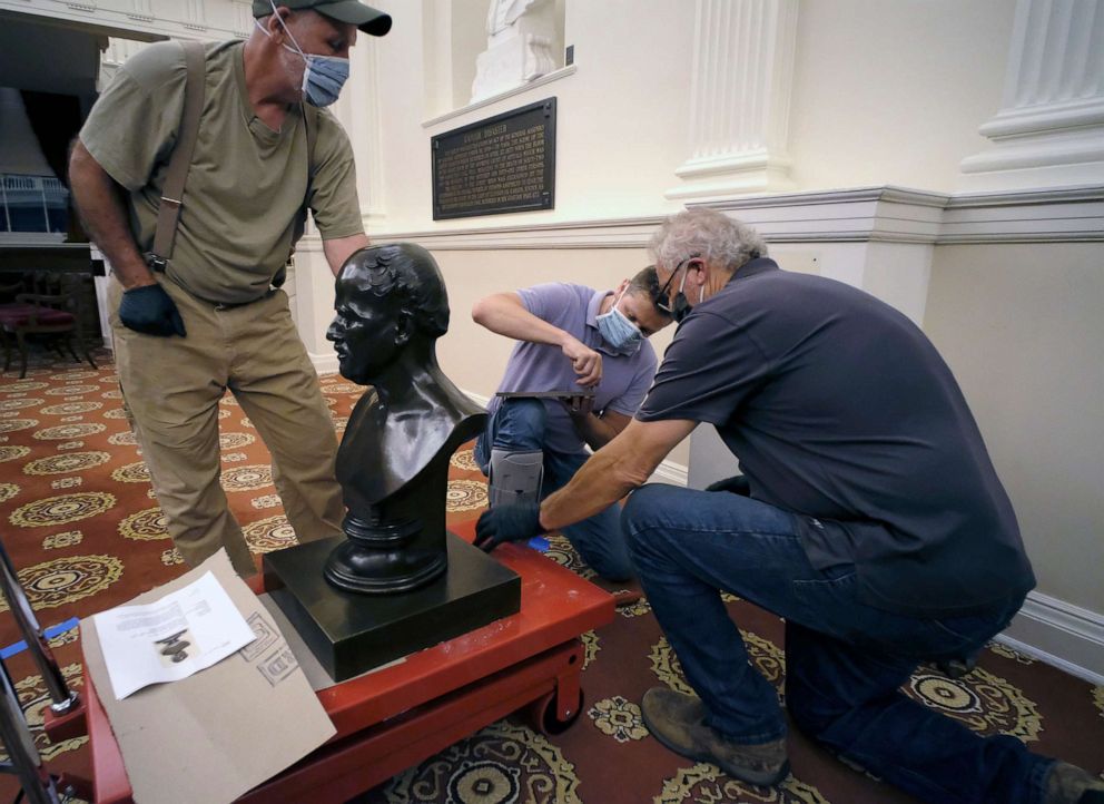 PHOTO: Workmen prepare to haul away a bust of Matthew Fontaine Maury in the Old House Chamber inside the Virginia State Capitol in Richmond, Va., July 23, 2020.