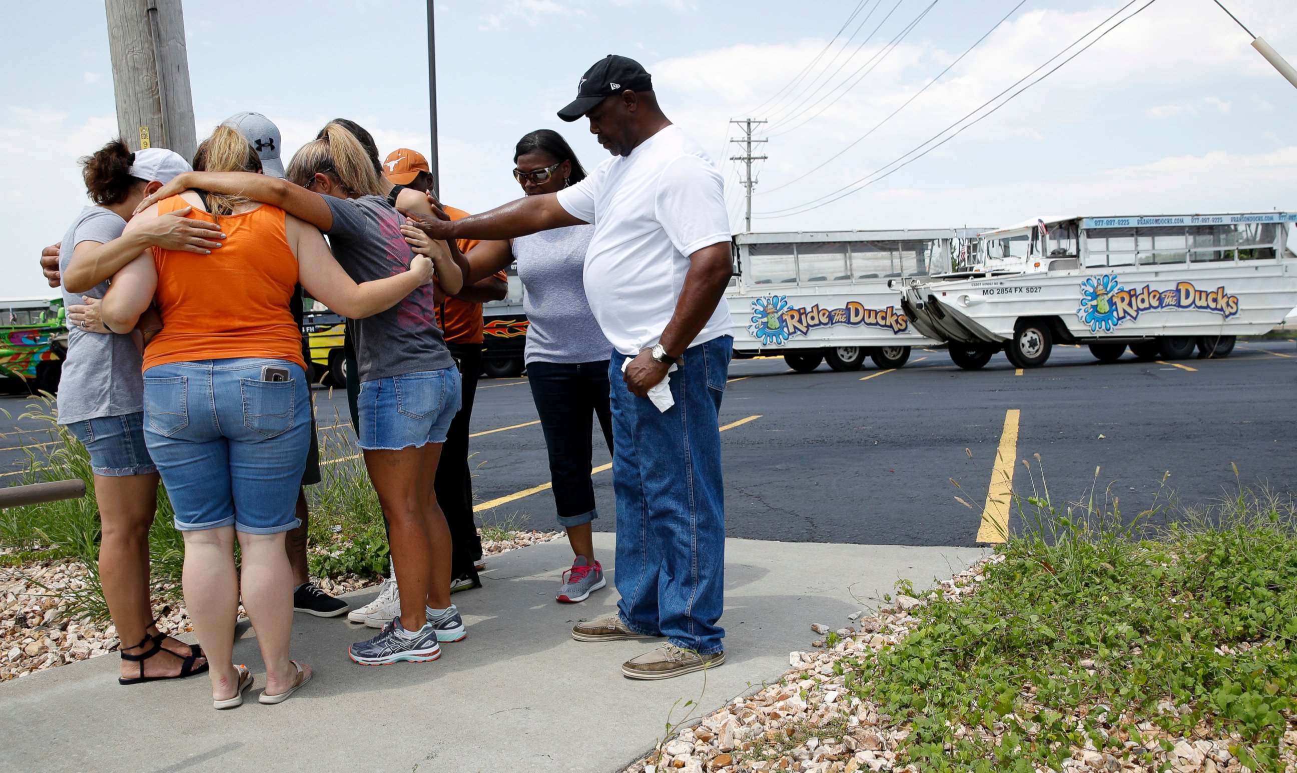 People pray outside Ride the Ducks, an amphibious tour operator involved in a boating accident on Table Rock Lake, Friday, July 20, 2018 in Branson, Mo.