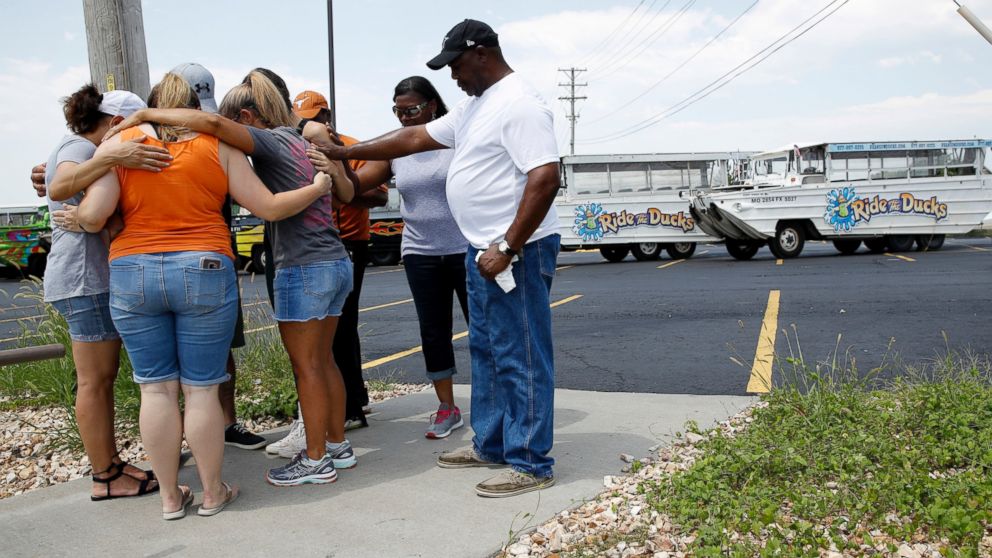 People pray outside Ride the Ducks, an amphibious tour operator involved in a boating accident on Table Rock Lake, Friday, July 20, 2018 in Branson, Mo.