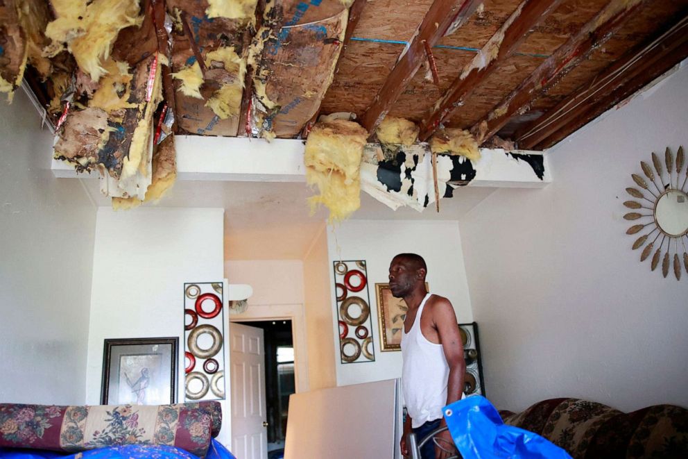 PHOTO: Wilbur Sandlin III looks at his roof that has not been fixed since July when a tree struck his rental home in Jacksonville, FLa., Sept. 28, 2022