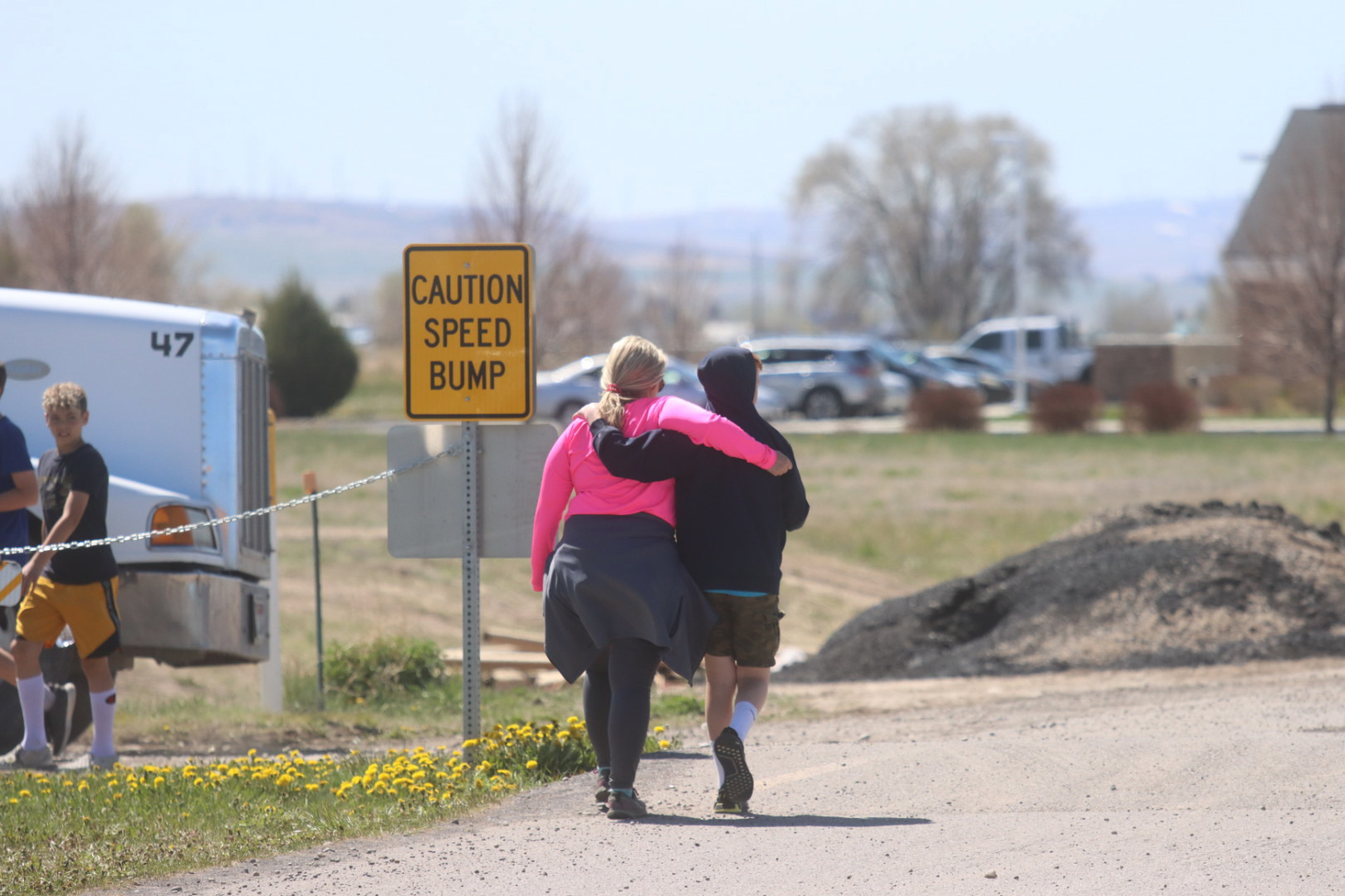 PHOTO: Two people walk together near the scene of a shooting at an eastern Idaho middle school Thursday, May 6, 2021, in Rigby, Idaho.