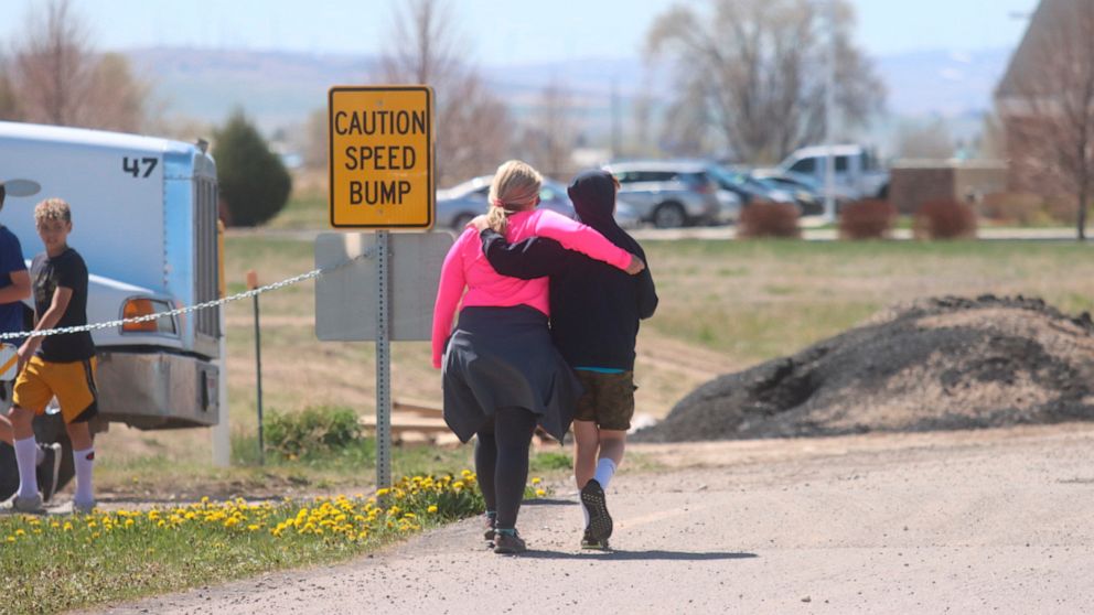 PHOTO: Two people walk together near the scene of a shooting at an eastern Idaho middle school Thursday, May 6, 2021, in Rigby, Idaho.