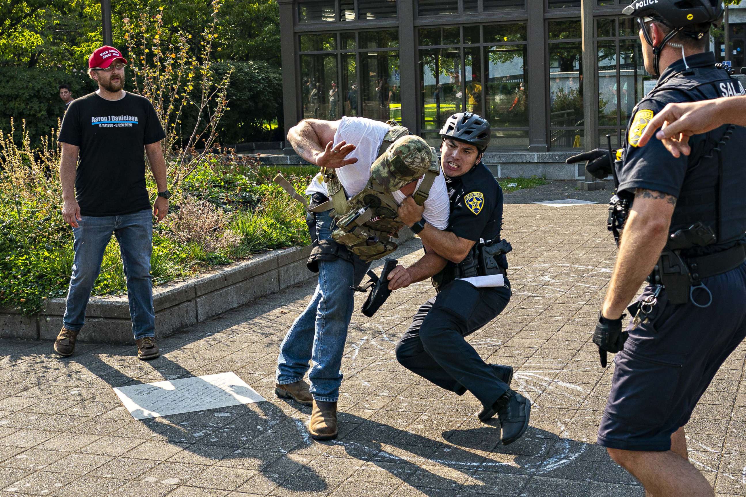 PHOTO: Police detain a right wing demonstrator following clashes with left wing demonstrators after a pro-Trump caravan rally convened at the Oregon State Capitol building on Sept. 7, 2020, in Salem, Oregon.