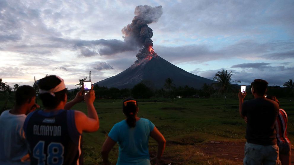 PHOTO: Residents watch the glowing lava flowing from the crater of the Mount Mayon volcano as it erupts in Albay Province, the Philippines, Jan. 23, 2018.