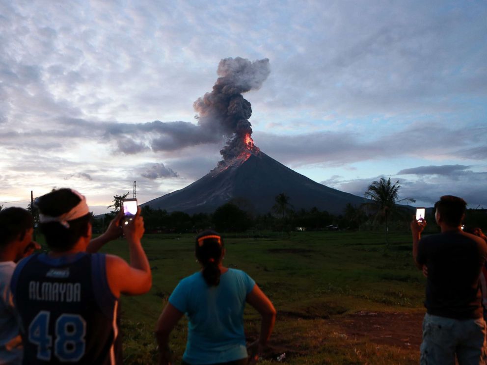 PHOTO: Residents watch the glowing lava flowing from the crater of the Mount Mayon volcano as it erupts in Albay Province, the Philippines, Jan. 23, 2018.
