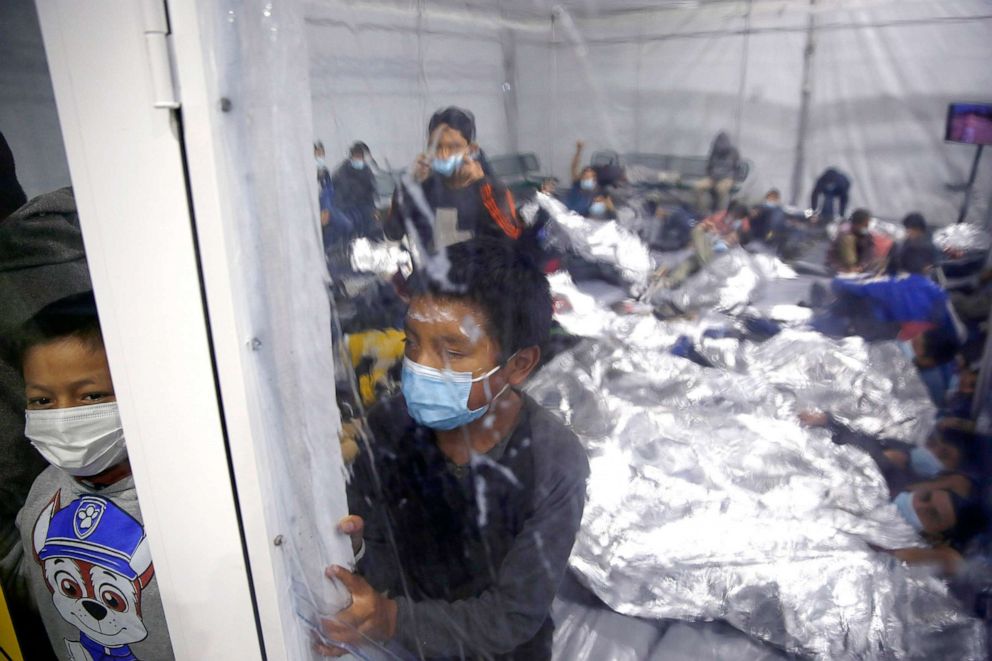 PHOTO: Children look out from inside a pod at the Donna Department of Homeland Security holding facility, the main detention center for unaccompanied children in the Rio Grande Valley, in Donna, Texas, March 30, 2021.