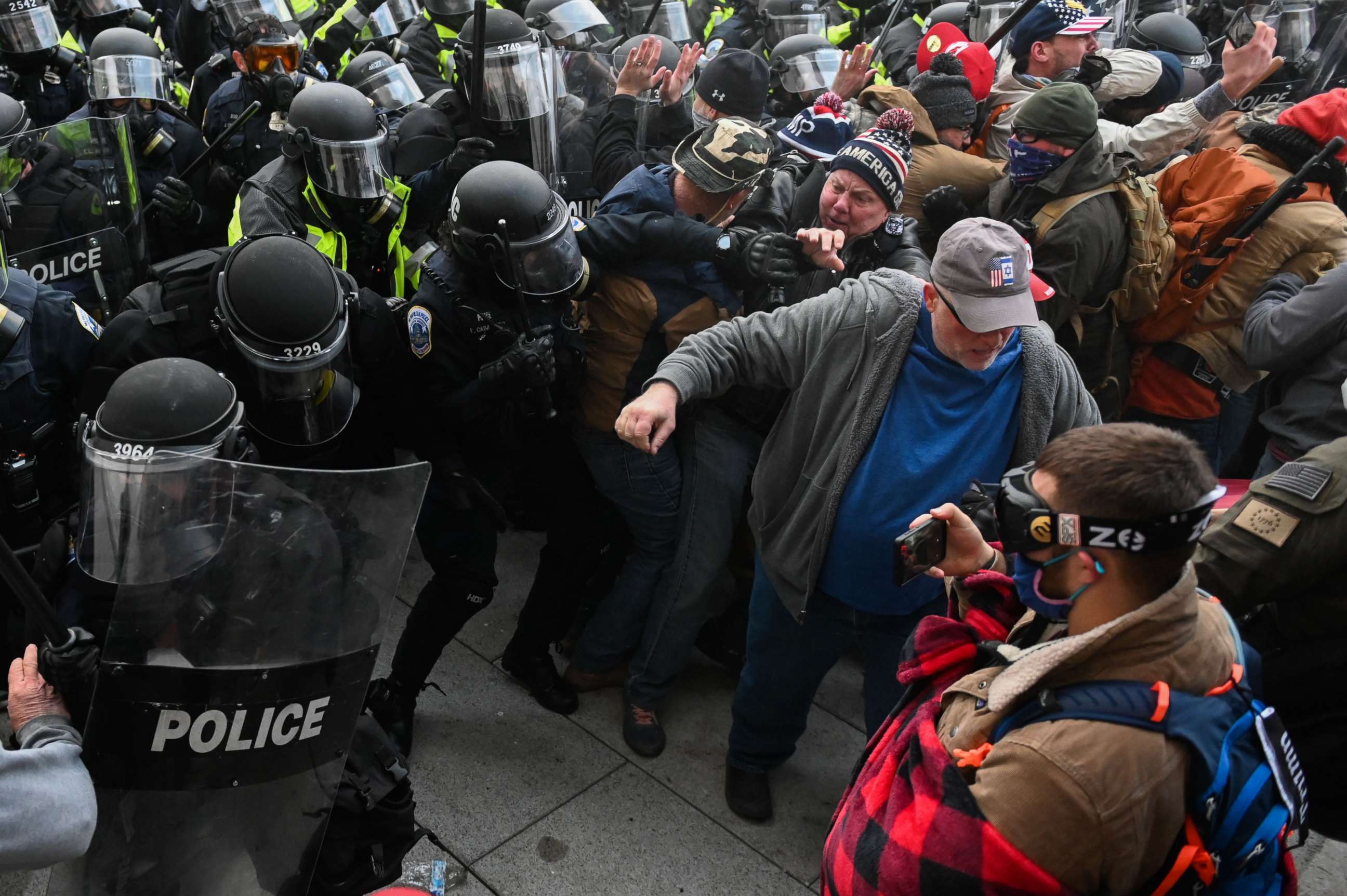 PHOTO: Riot police push back a crowd of supporters of US President Donald Trump after they stormed the Capitol building on January 6, 2021 in Washington, DC. 