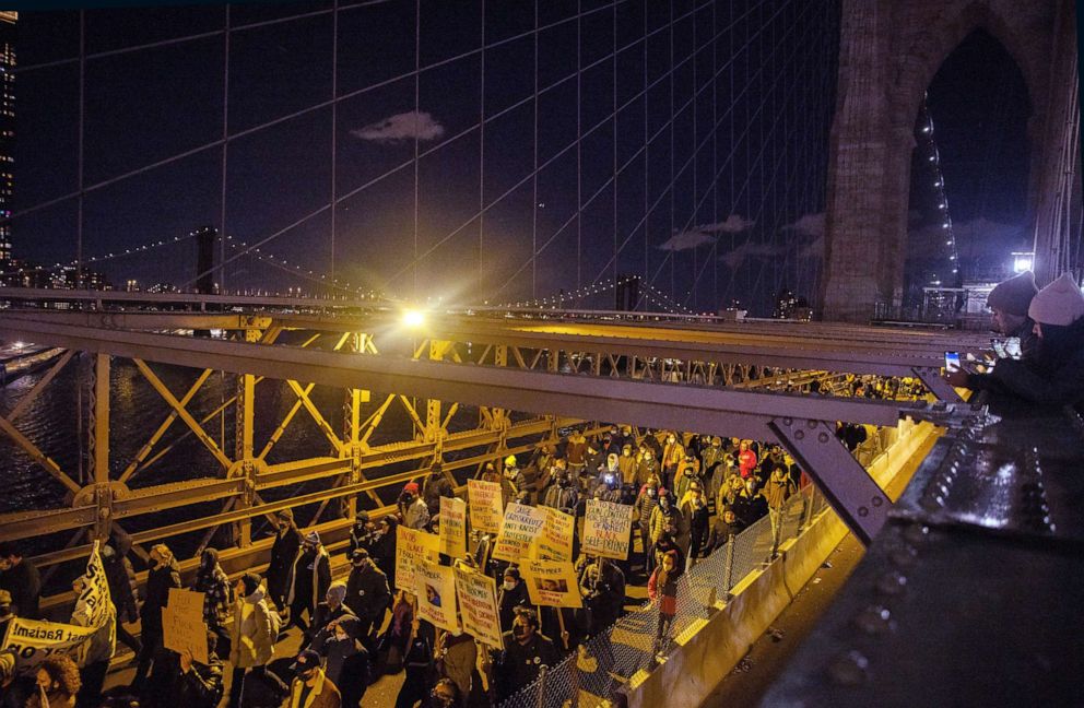 PHOTO: Demonstrators march across the Brooklyn Bridge, Nov. 19, 2021, in New York City, following the acquittal of Kyle Rittenhouse in Kenosha, Wis.