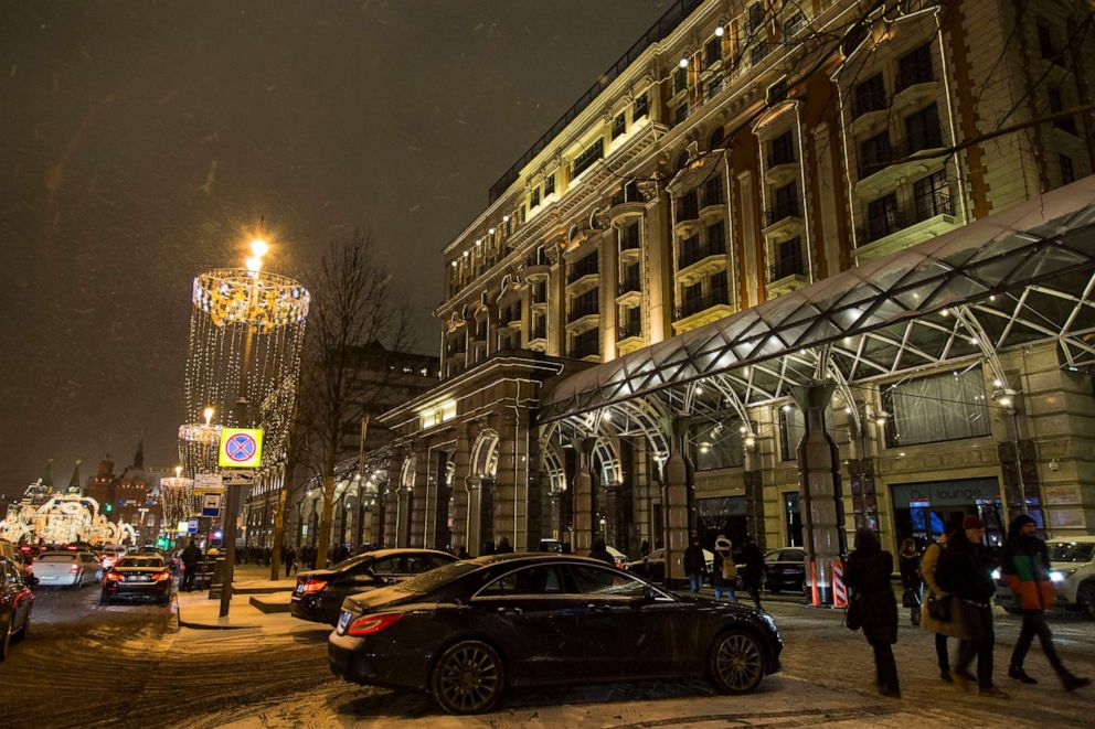 PHOTO: In this photo taken on Feb. 13, 2017, people walk past the Ritz-Carlton hotel, right, with Red Square behind in the background, in Moscow.