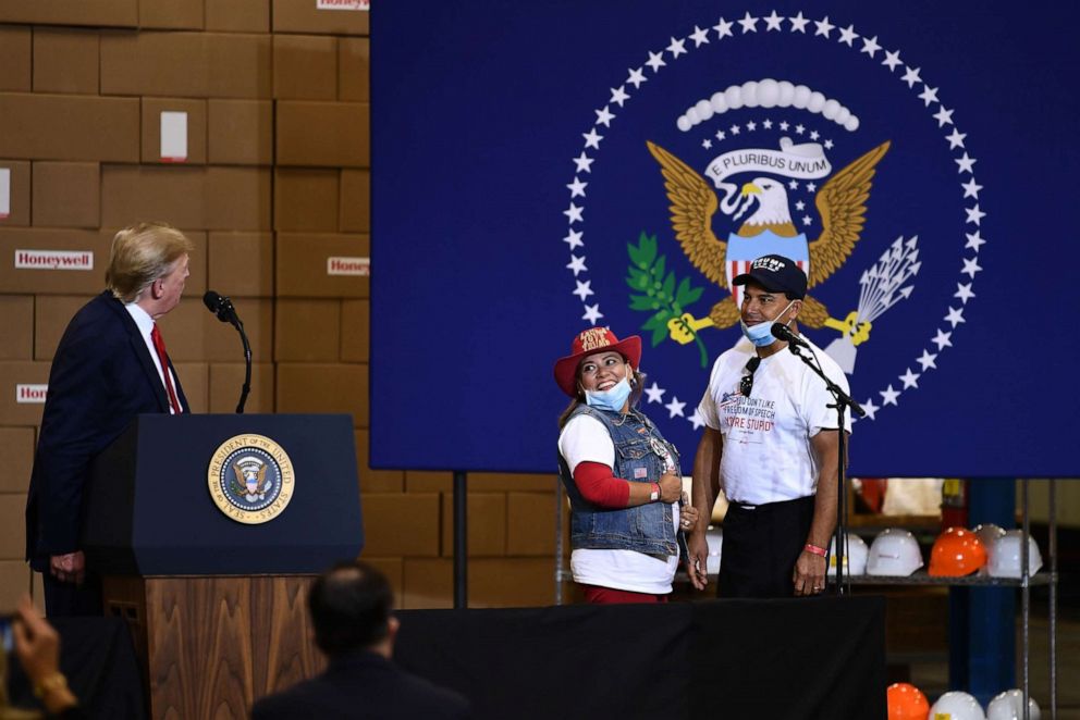 PHOTO: Jorge (R) and Betty Rivas, the owners of Sammy's Mexican Grill in Catalina, Arizona, address President Donald Trump during a tour of a Honeywell International plant that manufactures personal protective equipment in Phoenix, May 5, 2020.