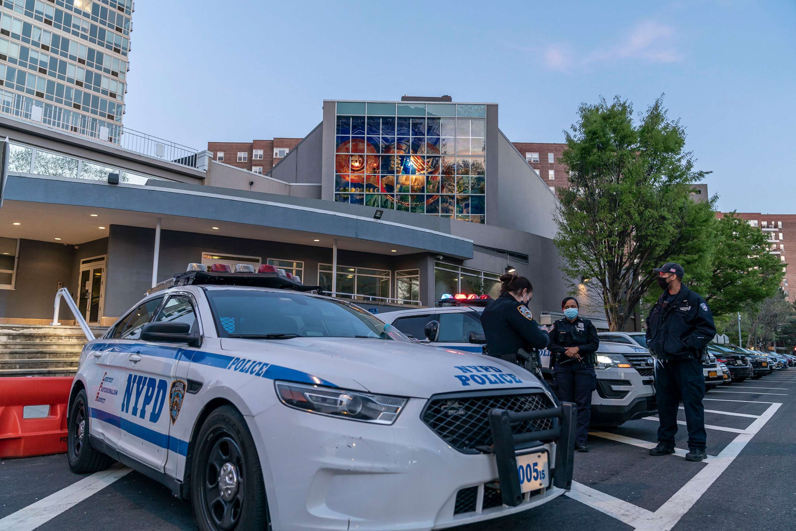 PHOTO: In this April 25, 2021, file photo, police stand guard in front of the Riverdale Jewish Center where glass doors and windows were smashed, in Riverdale, N.Y.