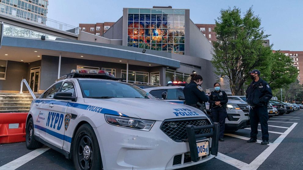 PHOTO: In this April 25, 2021, file photo, police stand guard in front of the Riverdale Jewish Center where glass doors and windows were smashed, in Riverdale, N.Y.