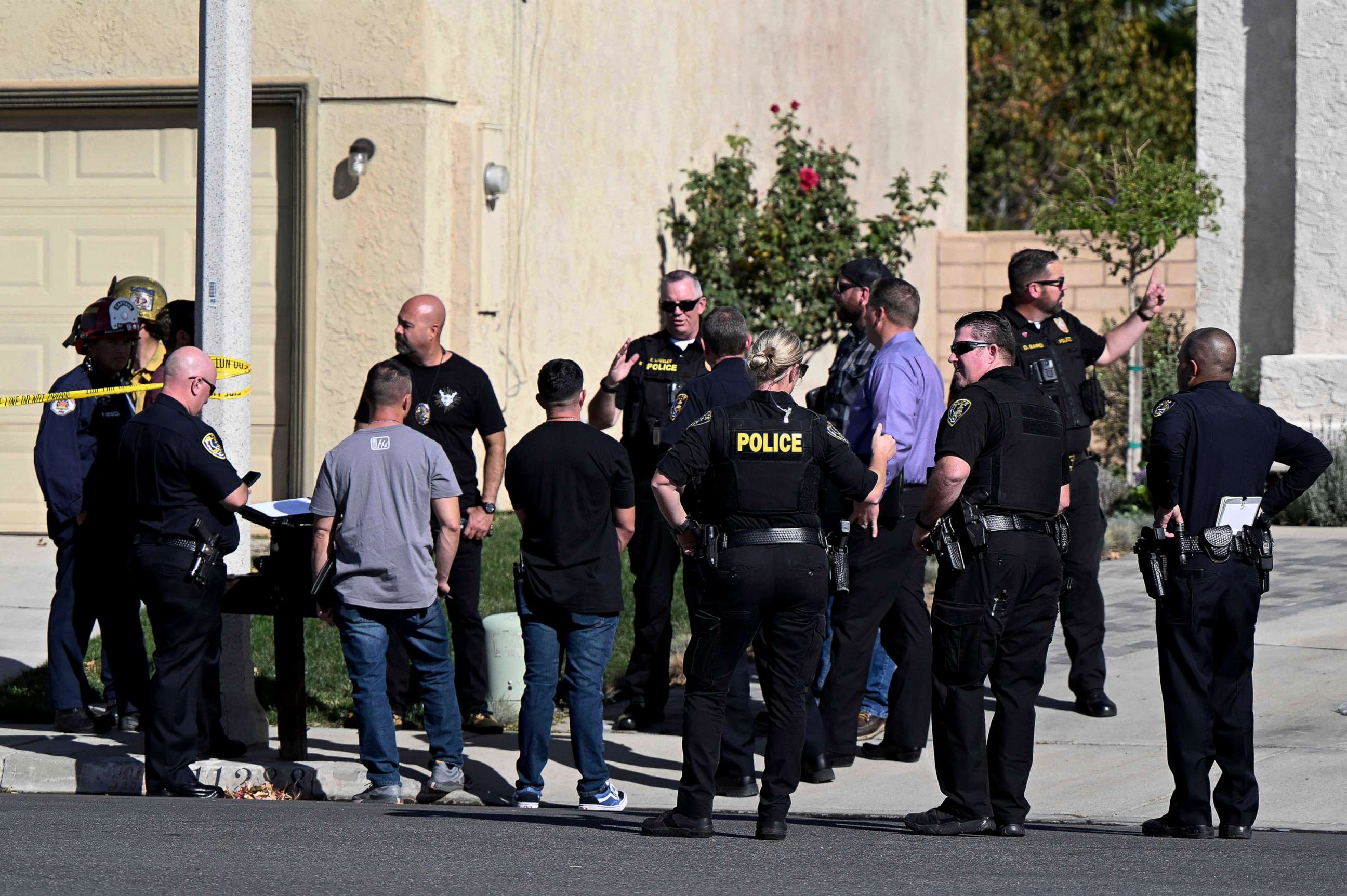 PHOTO: Firefighters and Riverside Police gather outside a burned home in Riverside, Calif., on Nov. 25, 2022, following a house fire. Three bodies were found in the house which police are investigating as a homicide.