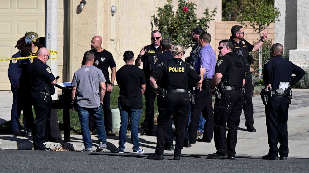 PHOTO: Firefighters and Riverside Police gather outside a burned home in Riverside, Calif., on Nov. 25, 2022, following a house fire. Three bodies were found in the house which police are investigating as a homicide.