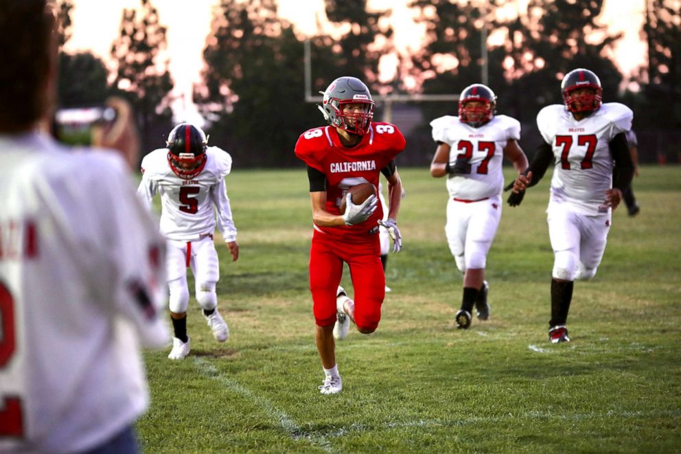 PHOTO: Wide receiver Jory Valencia #3, a student at the California School for the Deaf in Riverside, runs with the ball during one of the Cubs Varsity football team games in 2021.