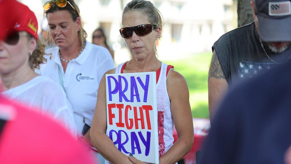 PHOTO: People pray during a vigil for Republican presidential candidate former President Donald Trump at Zeidler Union Square, July 14, 2024, in Milwaukee, Wisconsin.