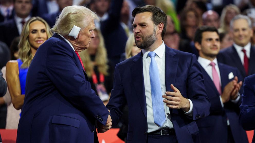 PHOTO: Former U.S. President Donald Trump greets Republican vice-presidential nominee JD Vance as he attends Day 1 of the Republican National Convention, in Milwaukee, July 15, 2024. 