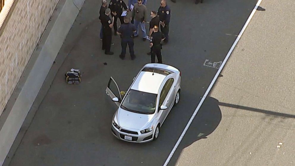 PHOTO: Investigators gather near a car where, according to authorities, a 6-year-old boy was fatally shot in a road rage incident on the 55 Freeway in Orange, Calif., May 21, 2021.
