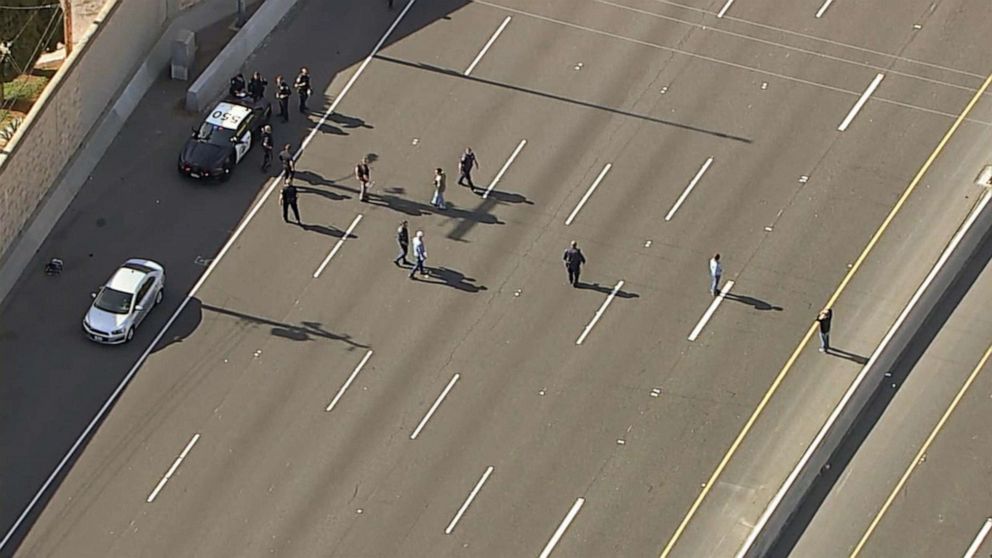 PHOTO: Investigators gather near a car where, according to authorities, a 6-year-old boy was fatally shot in a road rage incident on the 55 Freeway in Orange, Calif., May 21, 2021.