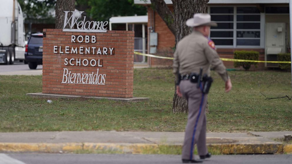 PHOTO: An officer walks outside Robb Elementary School in Uvalde, Texas, May 24, 2022. 