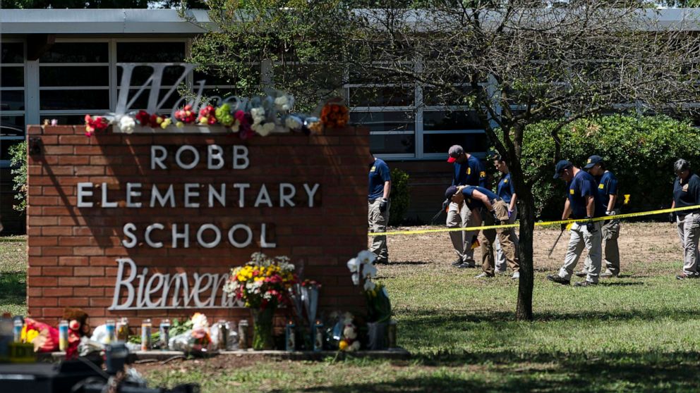 FILE PHOTO: Investigators search for evidence after an 18-year-old gunman killed 19 students and two teachers outside Robb Elementary School in Uwald, Texas, May 25, 2022.