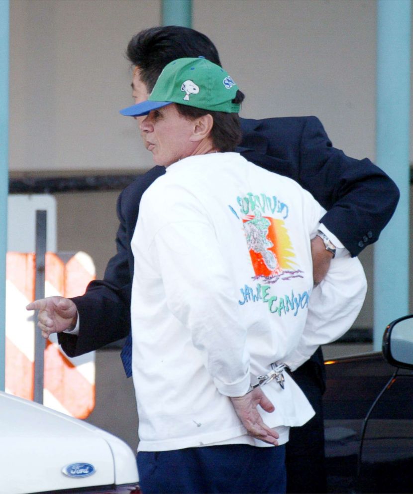 PHOTO: Robert Blake is escorted to Parker Center police headquarters, April 18, 2002, in Los Angeles.