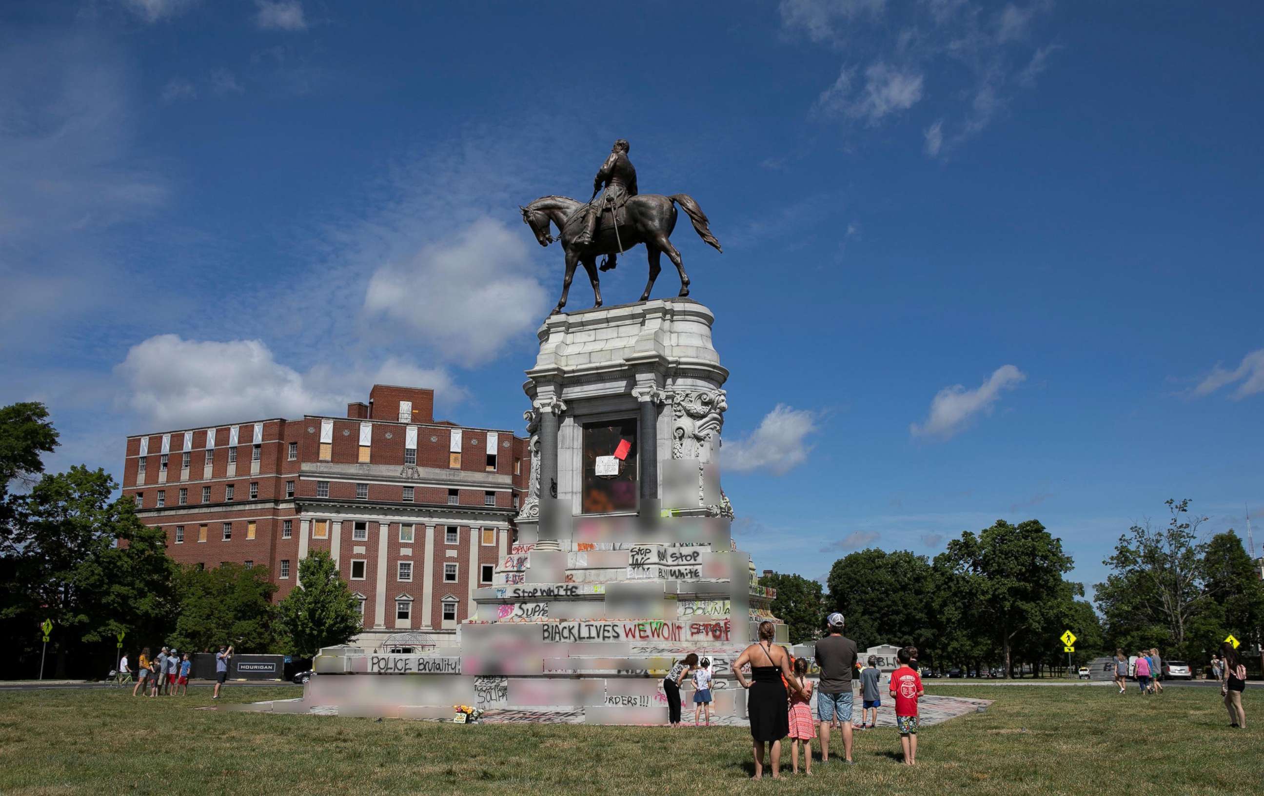 PHOTO: People visit a monument of Confederate general Robert E. Lee after Virginia Governor Ralph Northam ordered its removal after widespread civil unrest following the death in Minneapolis police custody of George Floyd, in Richmond, Va. June 5, 2020. 