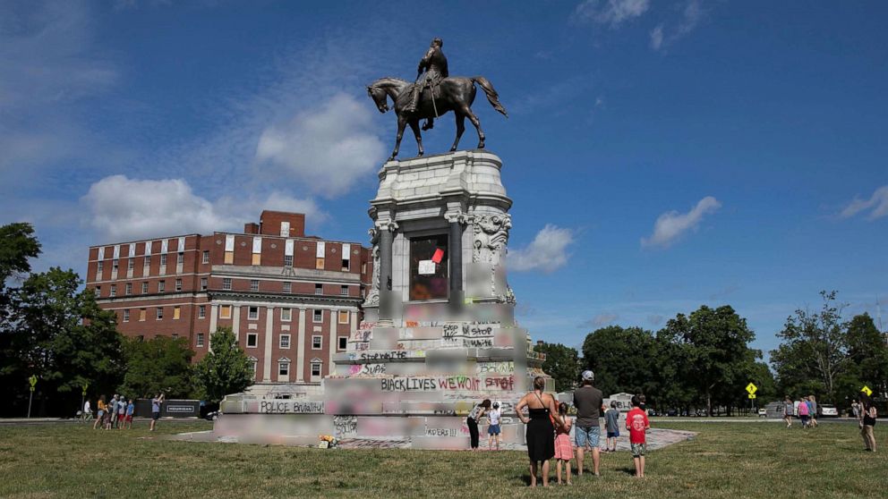 PHOTO: People visit a monument of Confederate general Robert E. Lee after Virginia Governor Ralph Northam ordered its removal after widespread civil unrest following the death in Minneapolis police custody of George Floyd, in Richmond, Va. June 5, 2020. 
