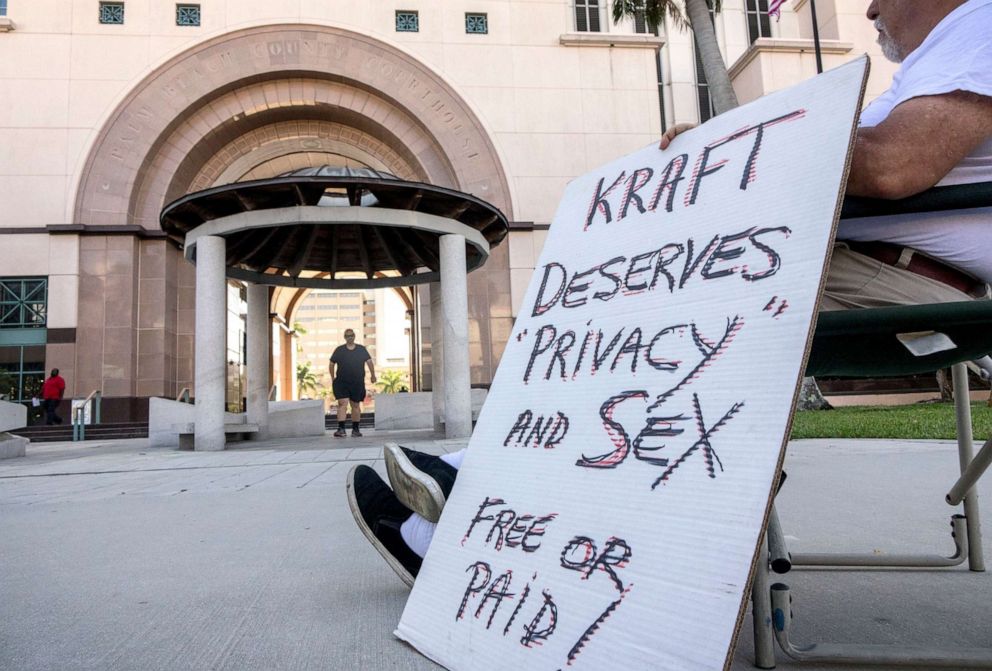 PHOTO: A man holds a banner supporting New England Patriots owner Robert Kraft in front of the Palm Beach County Courthouse, where the case disposition hearing in the State vs. Robert Kraft is happening, April 12, 2019, Palm Beach, Fla.
