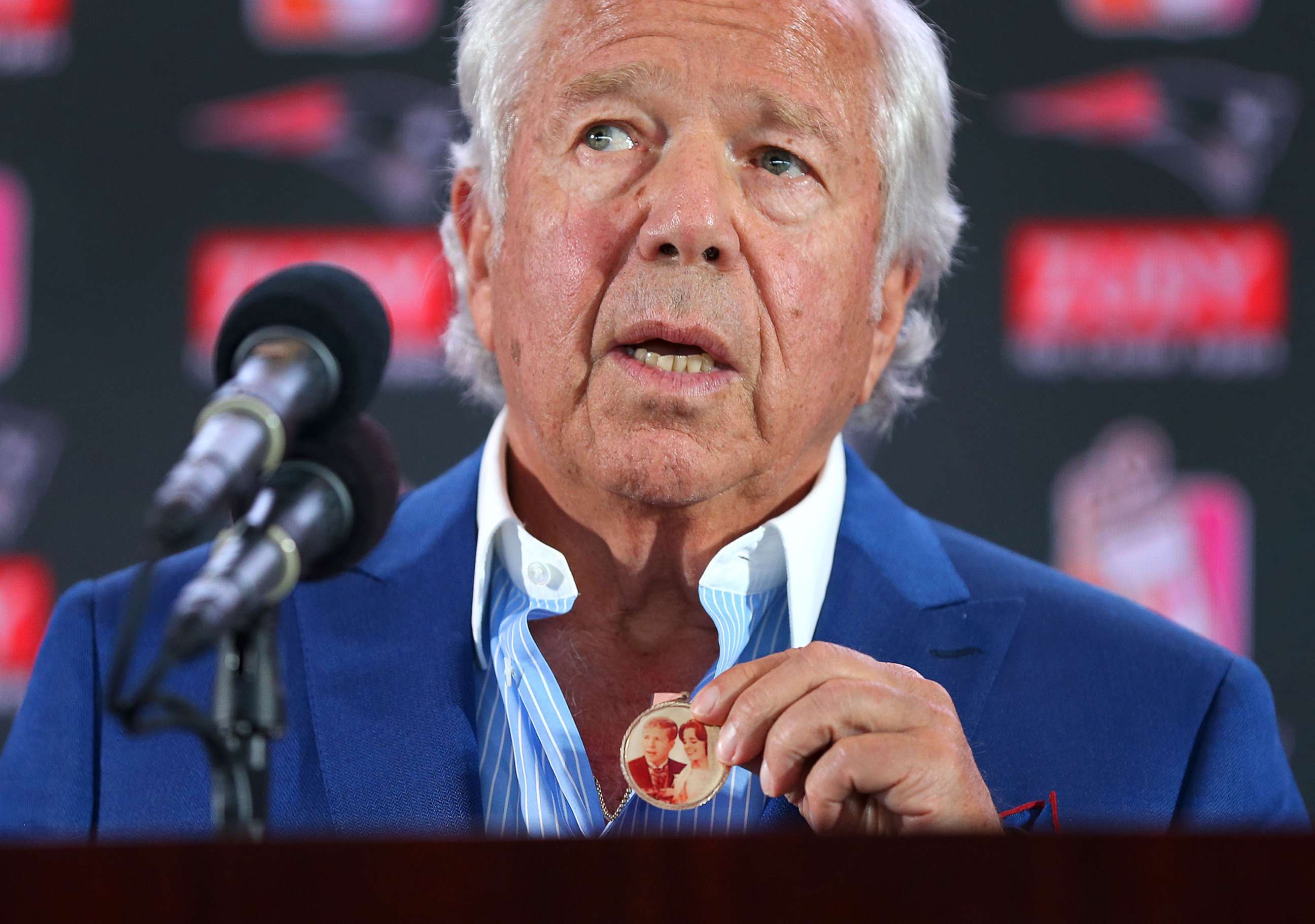PHOTO: New England Patriots owner Robert Kraft holds a medal containing a wedding photo of him and his late wife Myra at a press conference in Foxborough, Mass., Aug. 9, 2017. Kraft said he wore if for 11 months straight after she died.