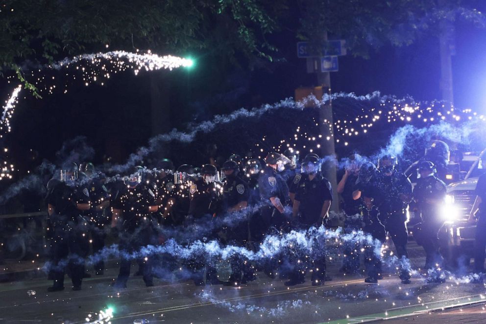PHOTO: Fireworks go off in front of police officers as they attempt to clear the streets after a march for Daniel Prude on Sept. 04, 2020, in Rochester, NY.