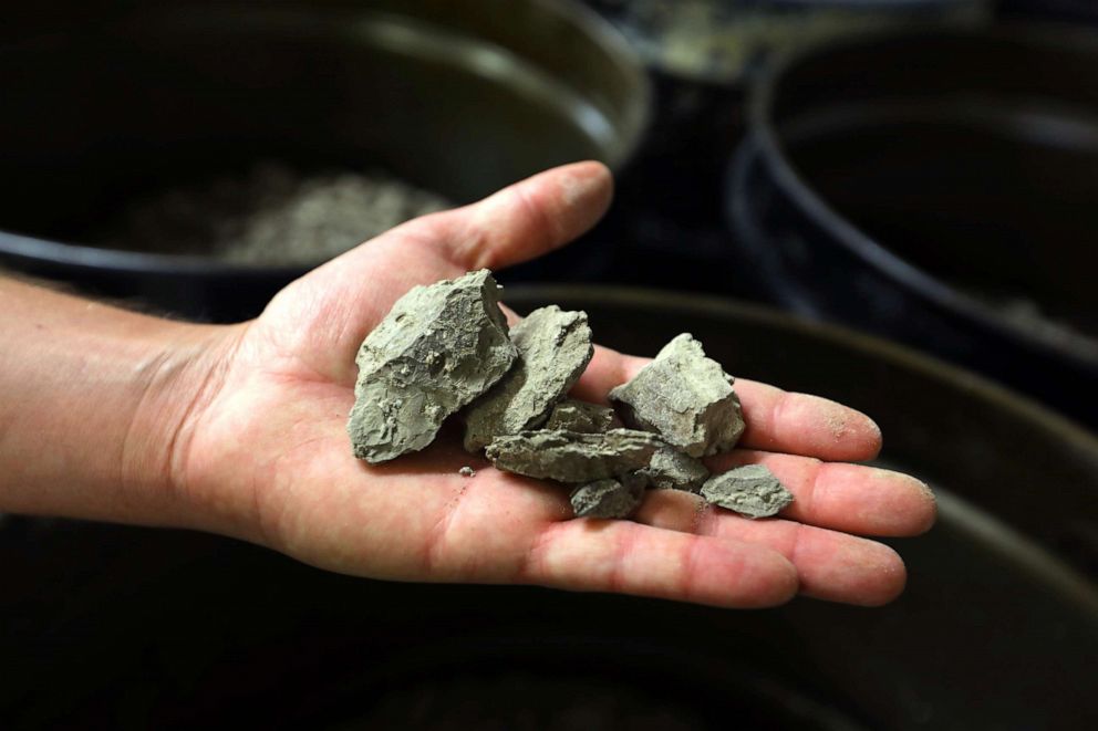 PHOTO: The clay mixture from which lithium will be extracted is held by Tim Crowley, spokesman for Lithium Americas Corp, June 7, 2021, in Reno, Nev.