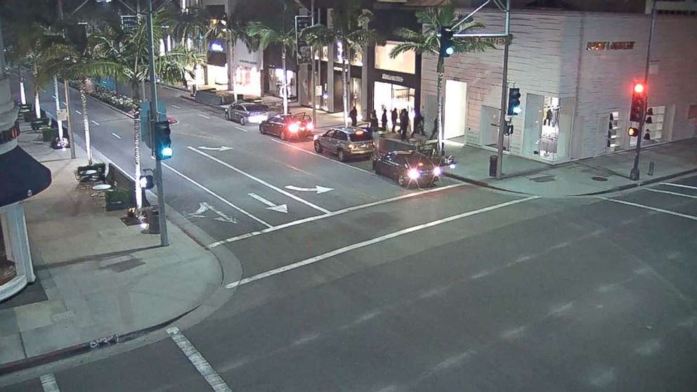 A screeengrab from a surveillance video showed four cars pull up and at least a dozen people emerge to burglarize stores on Beverly Hills' famous Rodeo Drive on Tuesday, May 29, 2018.