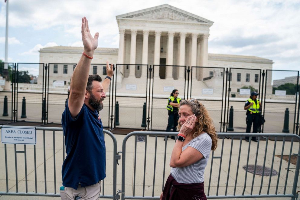 PHOTO: Anti-abortion activist Matt Lockett and Kim Lockett, his wife, react following the courts decision on the Dobbs v Jackson Women's Health Organization ruling outside the Supreme Court, June 24, 2022. 
