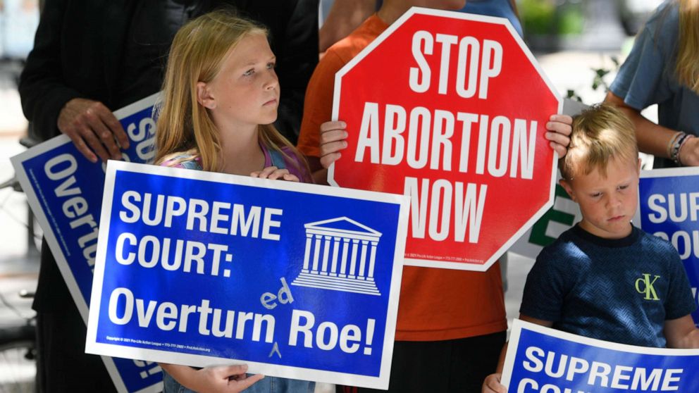 PHOTO: Grace Miller 11, left, and Leo Miller 5, right, hold signs during a Pro-Life rally at Federal Plaza Friday, June 24, 2022, in Chicago, after the Supreme Court overturned Roe vs Wade.