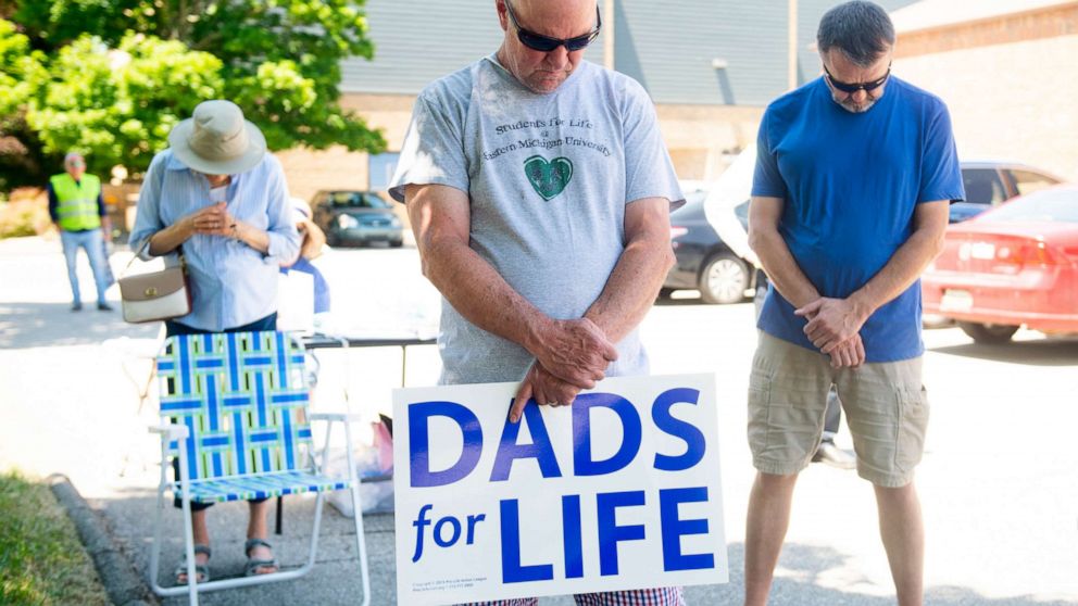 PHOTO: Rick Rainville bows his head in prayer at a rally of abortion opponents organized by Sidewalk Advocates for Life outside the Power Family Health Center Planned Parenthood  in Ann Arbor, Mich., June 24, 2022. 