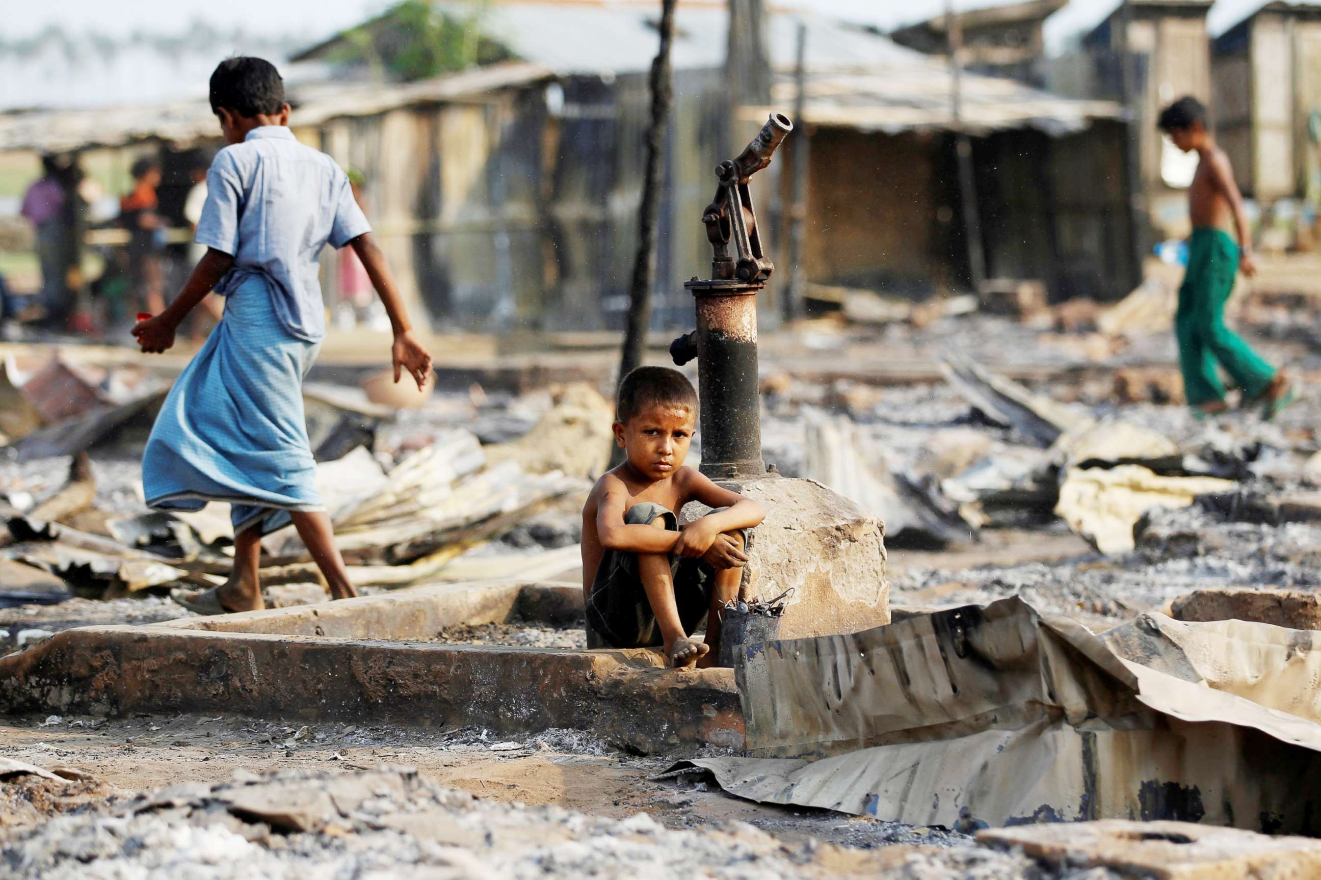 PHOTO: A boy sit in a burnt area after fire destroyed shelters at a camp for internally displaced Rohingya Muslims in the western Rakhine State near Sittwe, Myanmar, May 3, 2016.