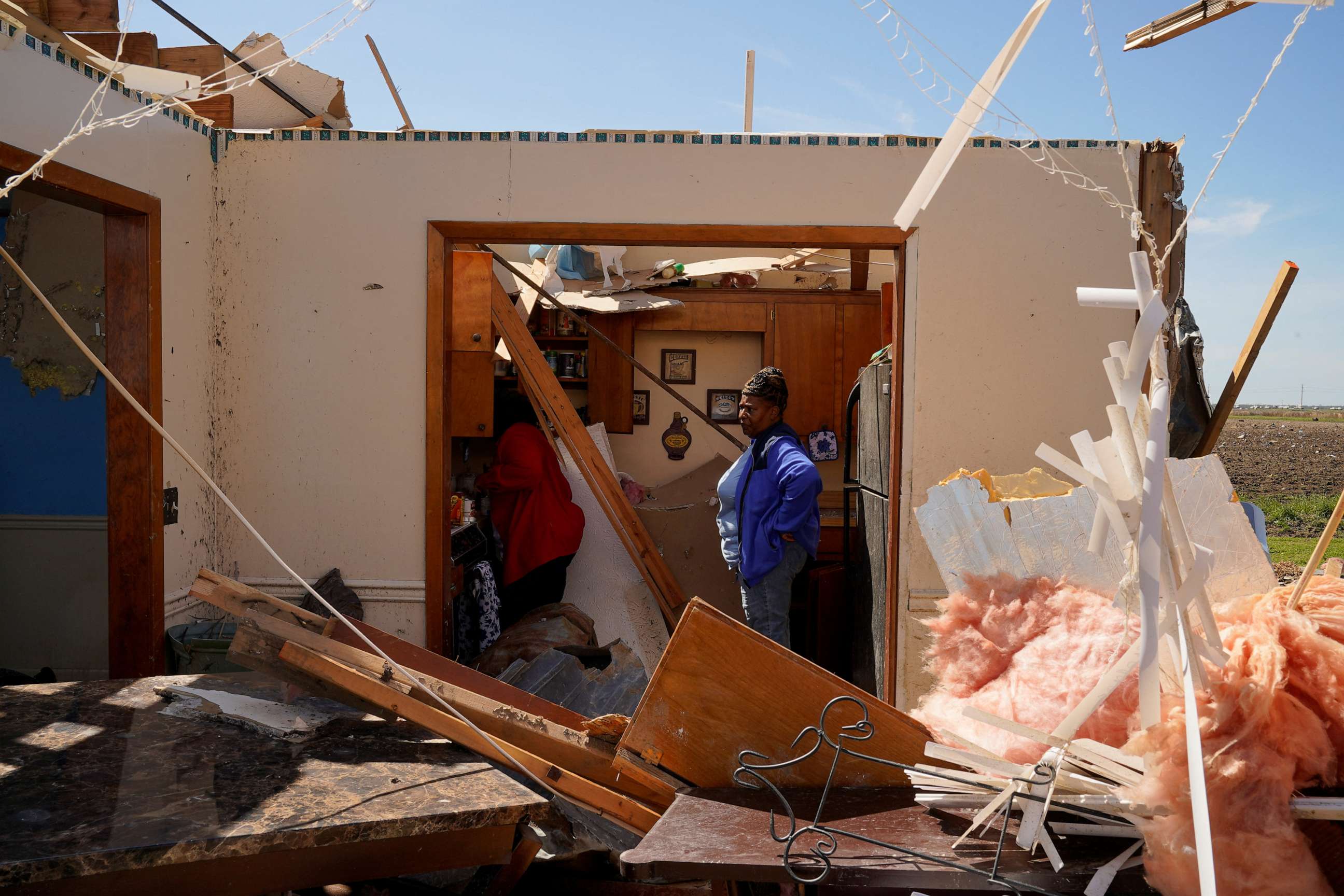 PHOTO: Chandra Wells, 47, and her sister Jennifer, 57, salvage items from the wreckage of Chandra's home after thunderstorms spawning high straight-line winds and tornadoes ripped across the state, in Rolling Fork, Miss., March 27, 2023.