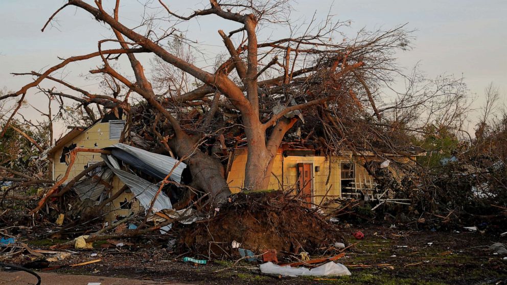 PHOTO: A house is seen crushed by a tree after thunderstorms spawning high straight-line winds and tornadoes ripped across the state in Rolling Fork, Miss., March 27, 2023.