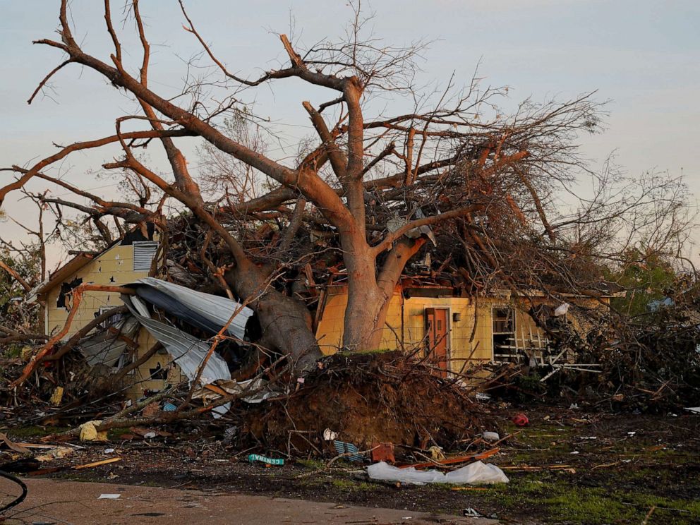 PHOTO: A house is seen crushed by a tree after thunderstorms spawning high straight-line winds and tornadoes ripped across the state in Rolling Fork, Miss., March 27, 2023.