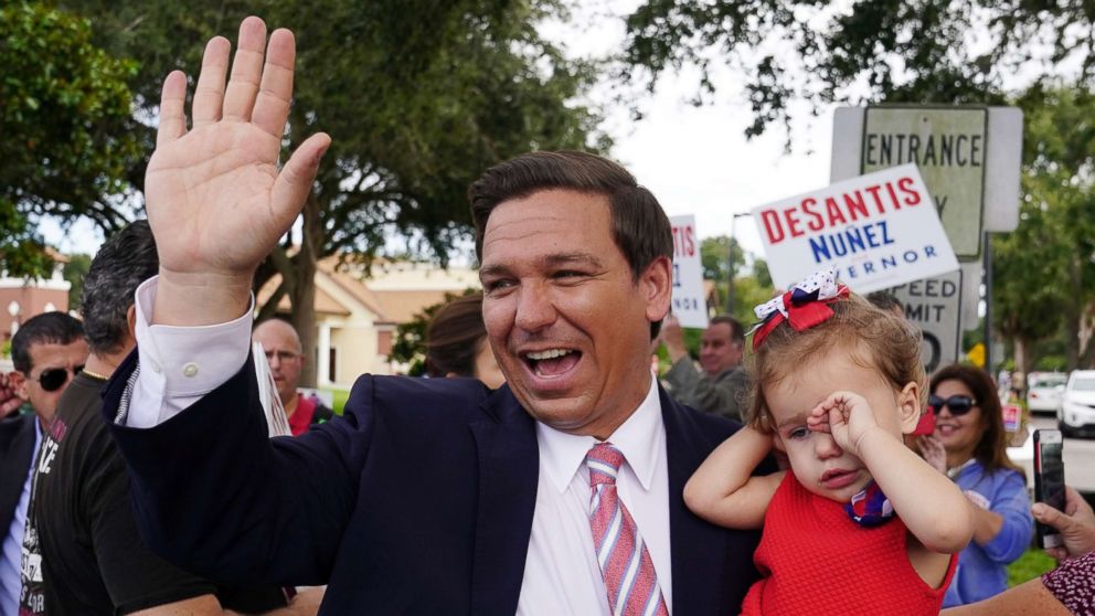 PHOTO: Republican candidate for Governor Ron DeSantis arrives to vote, carrying his daughter Madison, in Ponte Vedra Beach, Fla., Nov. 6, 2018.