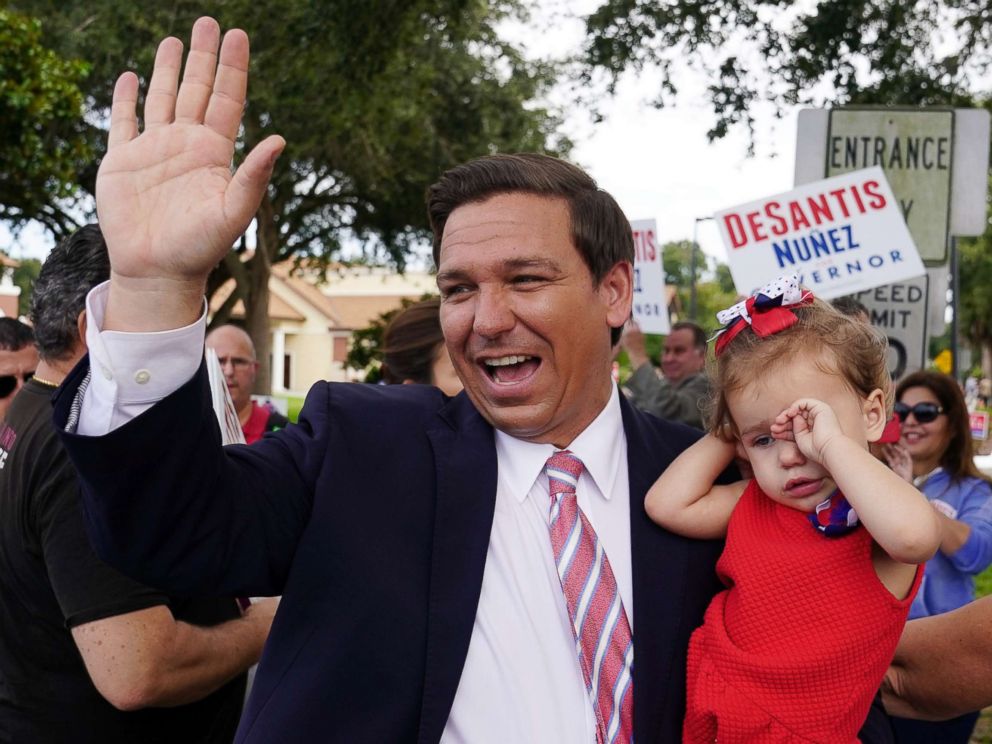 PHOTO: Republican candidate for Governor Ron DeSantis arrives to vote, carrying his daughter Madison, in Ponte Vedra Beach, Fla., Nov. 6, 2018.