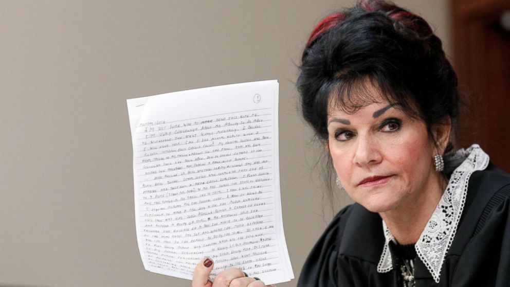 Judge Rosemarie Aquilina holds a letter written by Larry Nassar, a former team USA Gymnastics doctor, who pleaded guilty in November 2017 to sexual assault charges, during his sentencing hearing in Lansing, Michigan, Jan. 18, 2018. 