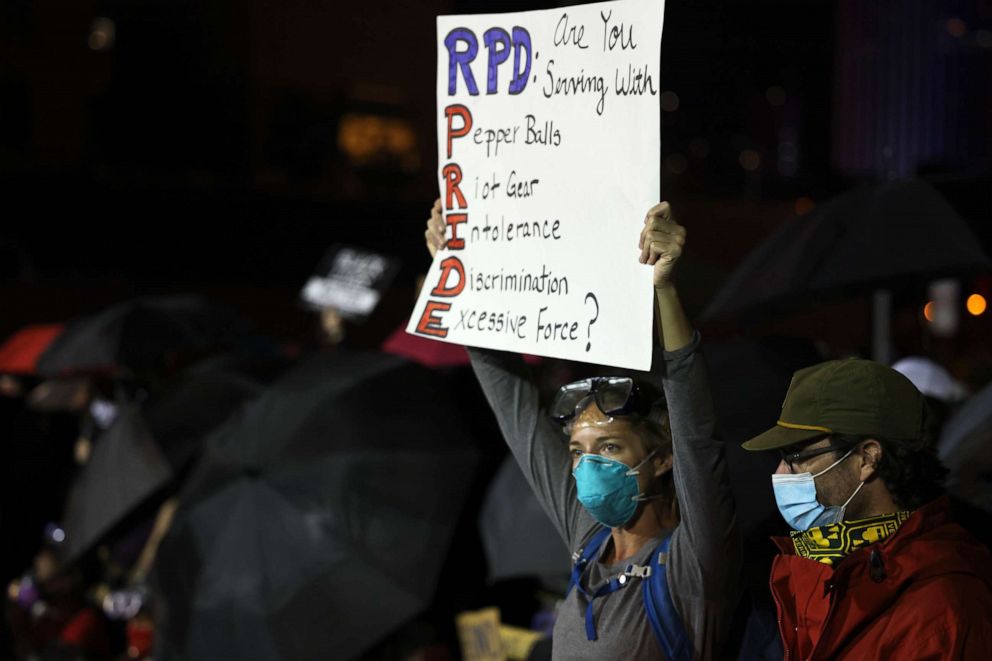 PHOTO: A woman holds up a sign during a standoff between demonstrators and police officers in front of the Public Safety Building after a peaceful march for Daniel Prude on Sept. 7, 2020 in Rochester, N.Y. 