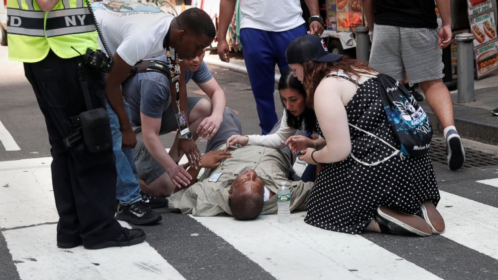 PHOTO: An injured man is helped on the sidewalk in Times Square after a speeding vehicle struck pedestrians on the sidewalk in New York City, May 18, 2017.