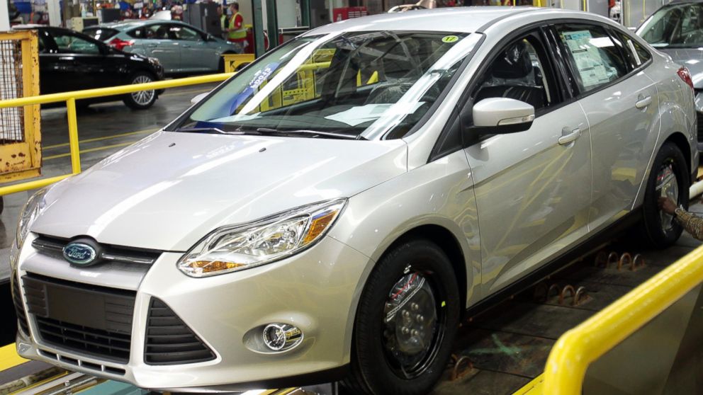 A Ford Motor assembly worker works on the final production line of the 2012 Ford Focus at Michigan Assembly Plant in Wayne, Michigan on March 17, 2011.