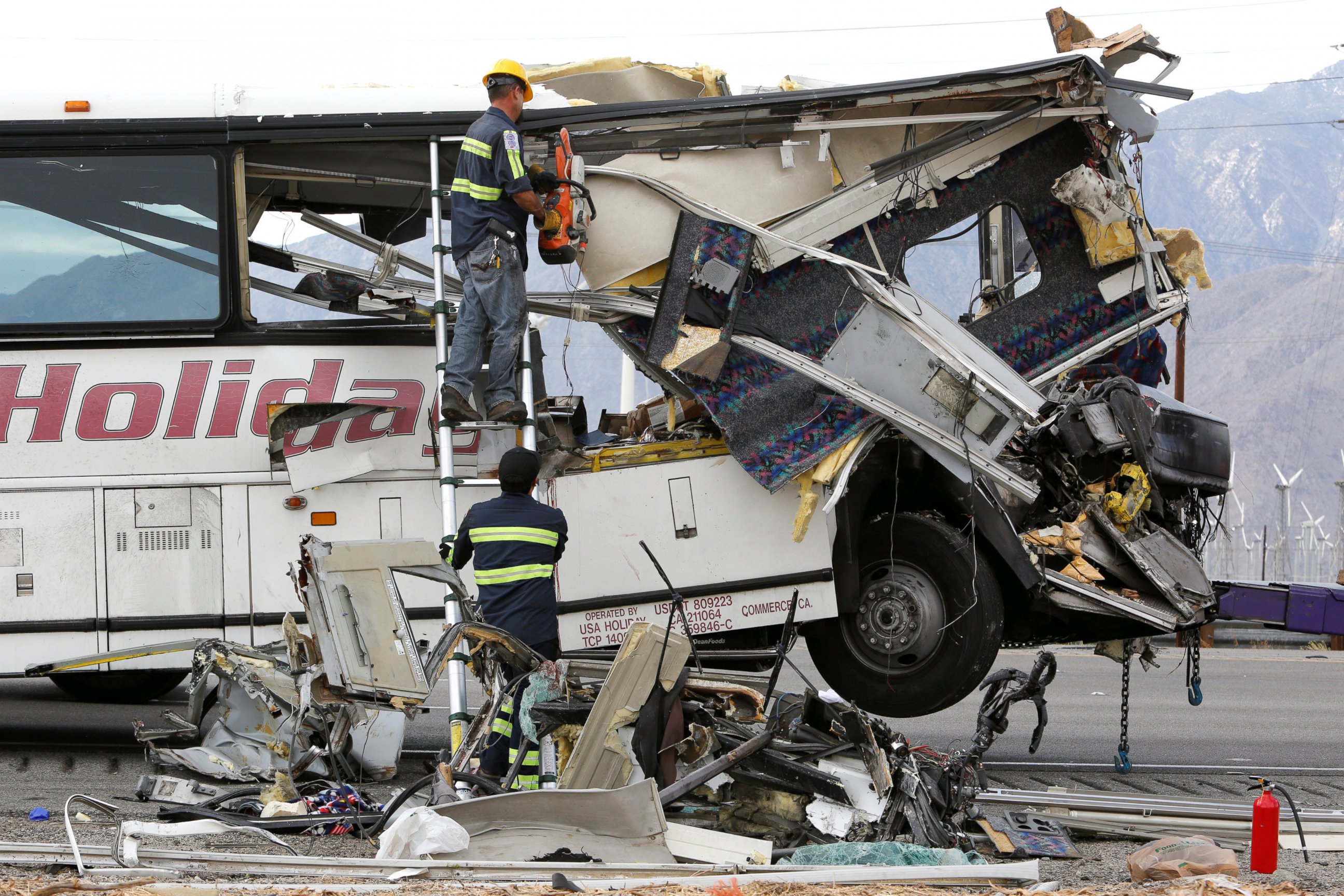 PHOTO: Workers cut away debris from the front of a bus involved in a mass casualty crash on the westbound Interstate 10 freeway near Palm Springs, California, Oct. 23, 2016.  